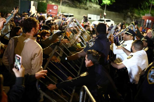 Protesters and law enforcement officers clash close to the scene where a man was shot by an Immigration and Customs Enforcement (ICE) officer during an operation in the Bronx borough of New York on October 8, 2026, according to local media and police. (Photo by CHARLY TRIBALLEAU / AFP)