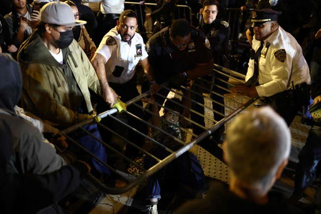 Protesters and law enforcement officers clash close to the scene where a man was shot by an Immigration and Customs Enforcement (ICE) officer during an operation in the Bronx borough of New York on October 8, 2026, according to local media and police. (Photo by CHARLY TRIBALLEAU / AFP)