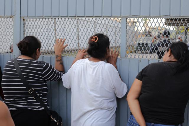 Women stand outside El Castillo prison following reports of a riot at the facility in Mazatlan, Mexico, on October 8, 2026. Ten people were killed and over a dozen injured after a fight broke out at a prison in Mexico's Sinaloa state on Thursday, the local government said. (Photo by Carlos Lopez / AFP)
