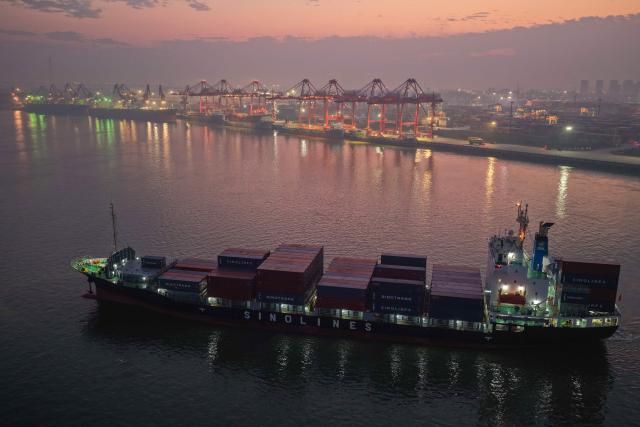 A cargo ship is seen at the container terminal of the port in Nanjing, in China’s eastern Jiangsu province on October 9, 2026. (Photo by CN-STR / AFP) / China OUT