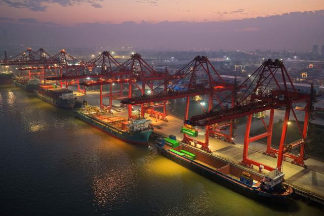 Cargo ships are seen at the container terminal of the port in Nanjing, in China’s eastern Jiangsu province on October 9, 2026. (Photo by CN-STR / AFP) / China OUT