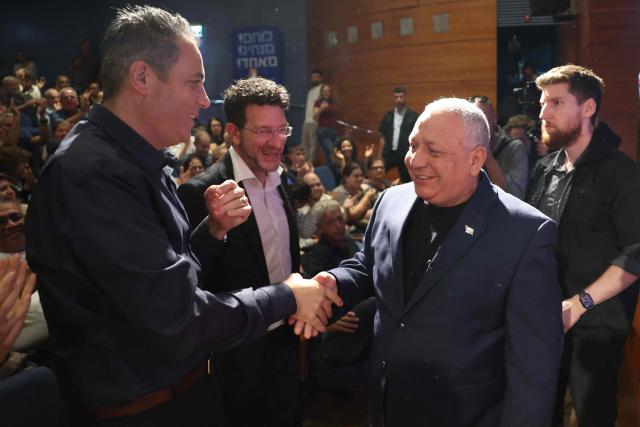 Former Israeli army chief of staff and Yashar Party leader Gadi Eizenkot (R) greets supporters during a campaign rally in Hadera on October 8, 2026, ahead of the country's legislative election. Israel will hold legislative elections on October 27, the first time since the October 7, 2023 attack with polls showing a tight race for the incumbent prime minister who in three years has ordered the massive offensive in the Gaza Strip and fought wars against Lebanon as well as Iran. (Photo by Jack GUEZ / AFP)