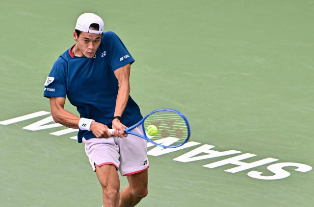 Japan's Rei Sakamoto hits a return to Russia's Andrey Rublev during their men's singles match at the Shanghai Master tennis tournament in Shanghai on October 9, 2026. (Photo by CN-STR / AFP) / China OUT