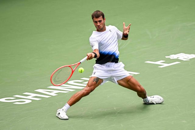 Italy's Flavio Cobolli hits a return to France's Adrian Mannarino during their men's singles match at the Shanghai Master tennis tournament in Shanghai on October 9, 2026. (Photo by CN-STR / AFP) / China OUT