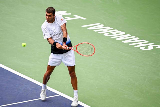 Italy's Flavio Cobolli hits a return to France's Adrian Mannarino during their men's singles match at the Shanghai Master tennis tournament in Shanghai on October 9, 2026. (Photo by CN-STR / AFP) / China OUT