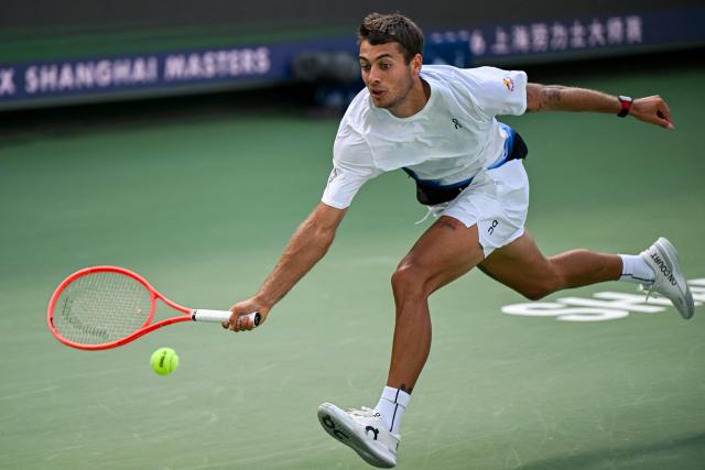 Italy's Flavio Cobolli hits a return to France's Adrian Mannarino during their men's singles match at the Shanghai Master tennis tournament in Shanghai on October 9, 2026. (Photo by CN-STR / AFP) / China OUT