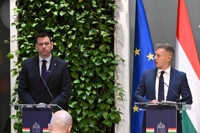 Hungarian Prime Minister Peter Magyar (R) and Minister for Transport and Investments David Vitezy address a press conference at the Prime Minister's Office in Budapest on October 9, 2026, following a cabinet meeting focused on the 2027 budget, child protection measures, and transport and investment policies. (Photo by Attila KISBENEDEK / AFP)