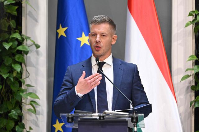 Hungarian Prime Minister Peter Magyar and the Minister for Transport and Investments address a press conference at the Prime Minister's Office in Budapest on October 9, 2026, following a cabinet meeting focused on the 2027 budget, child protection measures, and transport and investment policies. (Photo by Attila KISBENEDEK / AFP)