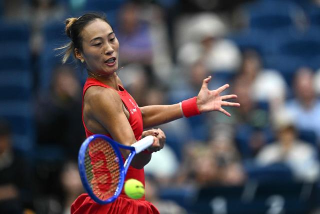 China’s Zheng Qinwen hits a return to Ukraine’s Elina Svitolina during their women’s singles quarter-final at the China Open tennis tournament in Beijing on October 9, 2026. (Photo by Pedro Pardo / AFP)