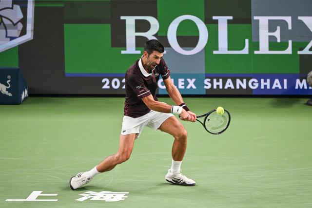Serbia's Novak Djokovic hits a return to Poland's Hubert Hurkacz during their men's singles match at the Shanghai Masters tennis tournament in Shanghai on October 9, 2026. (Photo by Hector RETAMAL / AFP)