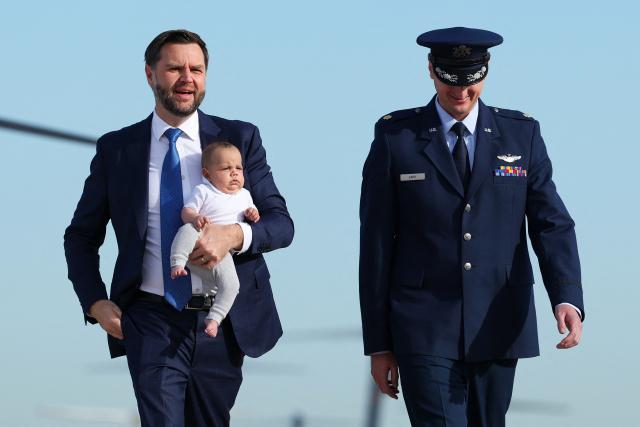 US Vice President JD Vance holds his son Alec Vance as he walks to board Air Force Two on October 9, 2026 at Joint Base Andrews, Maryland. Vance is traveling to Ohio to campaign for local Republican candidates ahead of the midterm elections. (Photo by Samuel Corum / POOL / AFP)