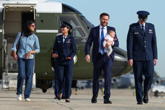 US Vice President JD Vance (2nd-R), holding his son Alec Vance, walks to board Air Force Two with second lady Usha Vance (L) on October 09, 2026 at Joint Base Andrews, Maryland. Vance is traveling to Ohio to campaign for local Republican candidates ahead of the midterm elections. (Photo by Samuel Corum / POOL / AFP)
