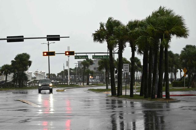 A car drives along a road in Pensacola Beach, Florida, on October 9, 2026, as Hurricane Isaias moves north toward the Florida Panhandle. Hurricane Isaias intensified to Category 2 in the Gulf of Mexico's warm waters on Thursday as it churned toward the southern United States, the National Hurricane Center (NHC) said.
The first hurricane of the Atlantic season, Isaias is forecast to make landfall in Florida, Alabama or Mississippi overnight Friday to Saturday, according to the NHC. (Photo by RONALDO SCHEMIDT / AFP)