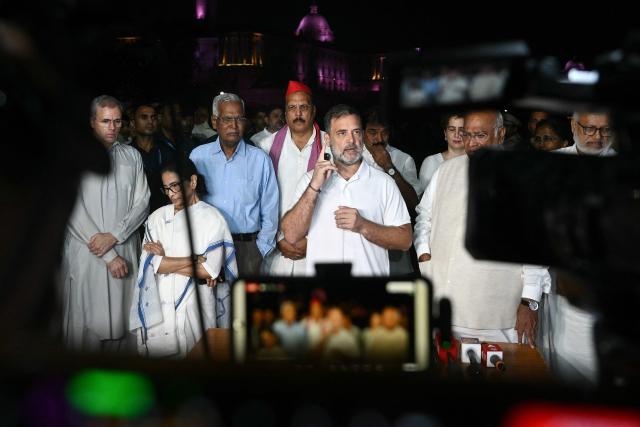 India's Congress party leader Rahul Gandhi (C) along with leaders of the opposition alliance INDIA bloc (Indian National Developmental Inclusive Alliance) speaks with media outside the Presidential Palace as they demand the resignation of India’s Chief Election Commissioner over alleged "special intensive revision” (SIR) voter-roll irregularities in New Delhi on October 9, 2026. (Photo by Arun SANKAR / AFP)