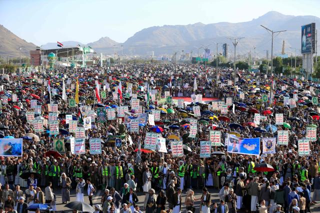 Supporters of the Houthi authorities hold up banners and flags during a protest against Saudi intervention in Yemen, in Sanaa, on October 9, 2026. The Houthis, who are fighting the Saudi-backed, internationally recognised government, seized the coastline alongside crucial trade route during a lightning offensive last month, extending their control over all of Yemen's Red Sea coast. Yemeni government forces have been attempting for several days to retake coastal territory captured by the pro-Iranian fighters. (Photo by Mohammed HUWAIS / AFP)