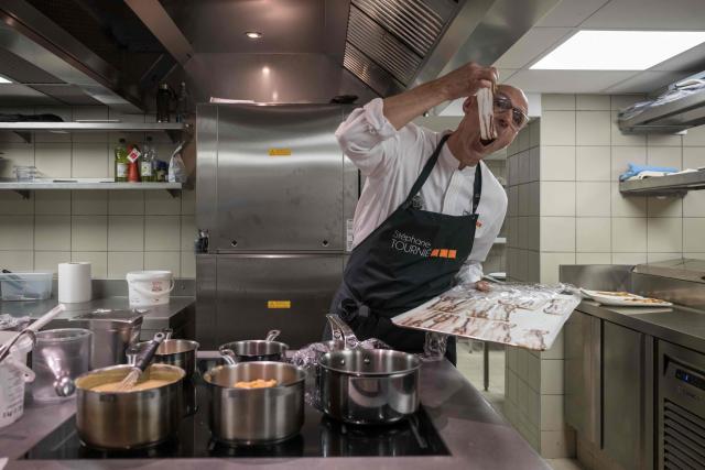 Michelin-starred chef Stephane Tournie works in his kitchen at the Hôtellerie des Laquets, at the Pic du Midi on October 9, 2026. France's highest hotel, the newly opened Hôtellerie des Laquets sits at an altitude of 2,620 metres in the Pyrenees, and was developed by the publicly backed Joint Syndicate for the Tourist Development of Pic du Midi. The four-star property offers 16 rooms, with rates starting at around 600 euros per night, and features a restaurant headed by Michelin-starred chef Stephane Tournié. (Photo by Ed JONES / AFP)
