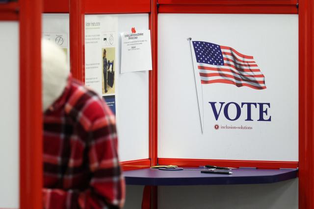 A person casts their ballot during early voting at the Hamilton County Board of Elections on October 09, 2026 in Norwood, Ohio. (Photo by Samuel Corum / POOL / AFP)