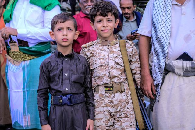 Two young supporters of the Houthi authorities pose for a photograph during a protest against the Saudi intervention in Yemen, in Hodeida on October 9, 2026. The Houthis, who are fighting the Saudi-backed, internationally recognised government, seized the coastline alongside crucial trade route during a lightning offensive last month, extending their control over all of Yemen's Red Sea coast. Yemeni government forces have been attempting for several days to retake coastal territory captured by the pro-Iranian fighters. (Photo by Zayed Al-Waqidi / AFP) / 