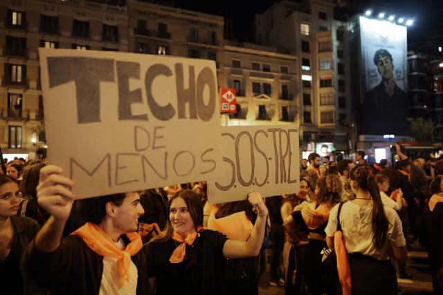 Demonstrators gather to pay tribute to Maricarmen Abascal, the 87-year-old pensioner whose eviction triggered nationwide protests over Spain's chronic housing crisis and a political debate that culminated in early elections, during a demonstration in Barcelona on October 9, 2026. Abascal, who died in hospital on October 7, became a symbol of Spain's housing market on September 23 when she was evicted from her life-long Madrid home on a stretcher after the real estate firm that owned the apartment drastically hiked the rent. (Photo by Lluis GENE / AFP)