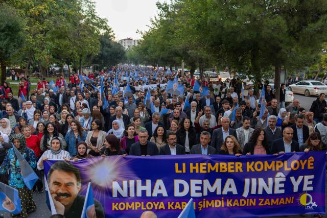 Demonstrators hold a banner reading "Now is the time for women to stand up against the conspiracy" as they protest on the anniversary of the expulsion from Syria of Abdullah Ocalan, jailed leader of the Kurdistan Workers' Party (PKK), in Diyarbakir on October 9, 2026. The PKK on October 6, 2026 accused the Turkish state of doing little to pursue the peace process that began in 2024, despite the Kurdish group having withdrawn all its combat forces from Turkey. Turkey's parliament in August voted through a law offering limited amnesty for militants from the Kurdistan Workers' Party (PKK) in the first legislative step to ending the conflict that has left some 50,000 people dead over decades of bloody conflict. The August law did not specify what will become of jailed PKK leader Abdullah Ocalan, 77, who has spent the past 27 years in solitary confinement on Imrali prison island near Istanbul. (Photo by Bilal Seckin / AFP)