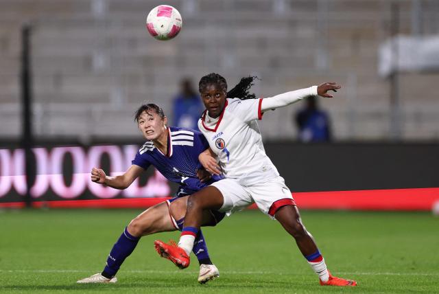 Japan's defender #02 Rion Ishikawa (L) and Haiti's forward #07 Batcheba Louis fight for the ball  during the women's international friendly football match between Haiti and Japan at the Bauer Stadium in Saint-Ouen, north of Paris, on October 9, 2026. (Photo by FRANCK FIFE / AFP)