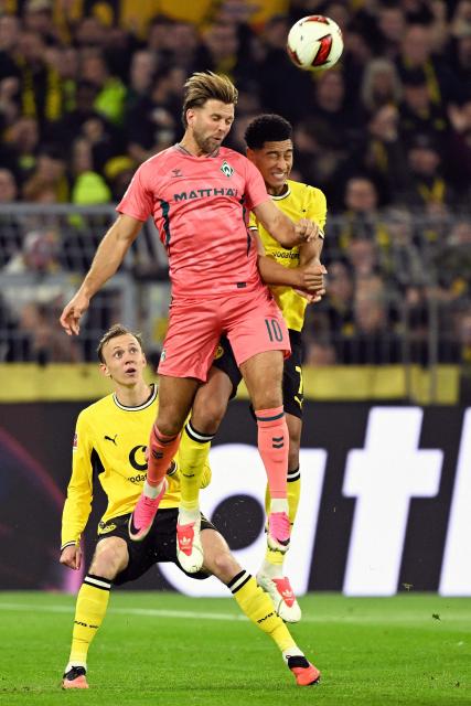 Bremen's German forward #10 Niclas Fuellkrug and Dortmund's English midfielder #07 Jobe Bellingham both jump to head the ball during the German first division Bundesliga football match between BVB Borussia Dortmund and Werder Bremen in Dortmund, western Germany on October 9, 2026. (Photo by INA FASSBENDER / AFP) / DFB REGULATIONS PROHIBIT ANY USE OF PHOTOGRAPHS AS IMAGE SEQUENCES AND QUASI-VIDEO.   ALTERNATIVE CROP