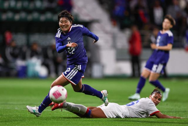 Japan's midfielder #22 Remina Chiba (L) fights for the ball with Haiti's defender #16 Claire Constant  during the women's international friendly football match between Haiti and Japan at the Bauer Stadium in Saint-Ouen, north of Paris, on October 9, 2026. (Photo by FRANCK FIFE / AFP)