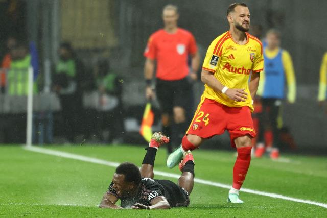 Lyon's Belgian forward #17 Lois Openda (L) is tackled by Lens' French defender #24 Jonathan Gradit (R) during the French L1 football match between RC Lens and Olympique Lyonnais (OL) at the Stade Bollaert-Delelis in Lens, northern France, on October 9, 2026. (Photo by Sameer AL-DOUMY / AFP)