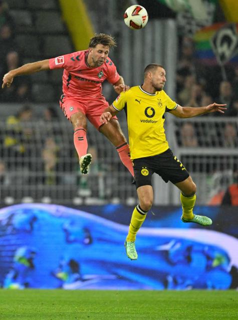 Bremen's German forward #10 Niclas Fuellkrug (L) and Dortmund's German defender #03 Waldemar Anton both jump to head the ball during the German first division Bundesliga football match between BVB Borussia Dortmund and Werder Bremen in Dortmund, western Germany on October 9, 2026. (Photo by INA FASSBENDER / AFP) / DFL REGULATIONS PROHIBIT ANY USE OF PHOTOGRAPHS AS IMAGE SEQUENCES AND/OR QUASI-VIDEO