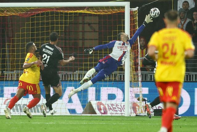 Lyon's Slovak goalkeeper #01 Dominik Greif reaches for the ball during the French L1 football match between RC Lens and Olympique Lyonnais (OL) at the Stade Bollaert-Delelis in Lens, northern France, on October 9, 2026. (Photo by Sameer AL-DOUMY / AFP)