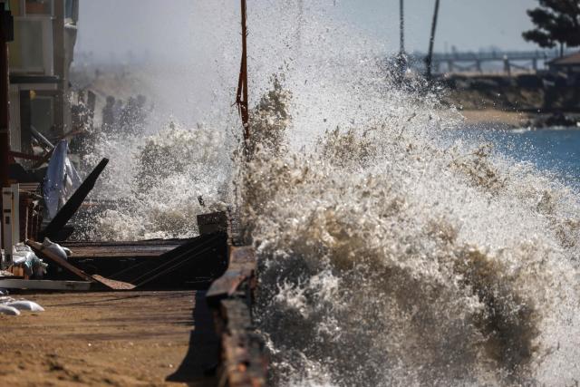 Strong waves crash onto the boardwalk and beachfront houses in Long Beach, California, on October 9, 2026. The National Weather Service office in San Diego on October 9 issued a rare tropical storm watch for most of San Diego County, in Southern California, meaning that tropical storm-force winds are possible somewhere in the area over the next 48 hours. It’s only the second time a tropical storm watch has ever been issued in California. (Photo by David Swanson / AFP)