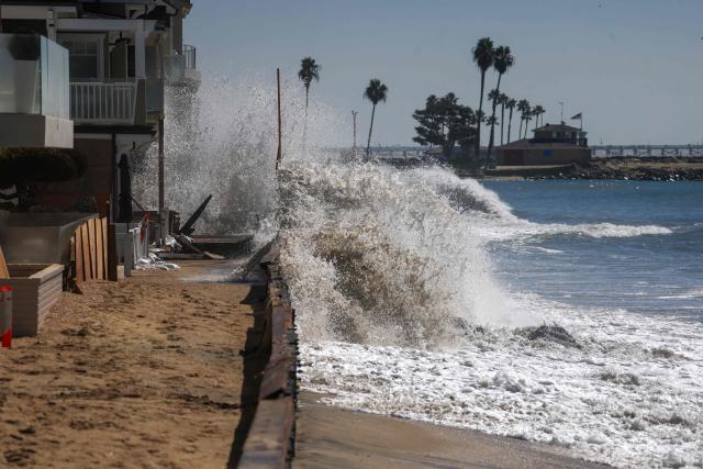 Strong waves crash onto the boardwalk and beachfront houses in Long Beach, California, on October 9, 2026. The National Weather Service office in San Diego on October 9 issued a rare tropical storm watch for most of San Diego County, in Southern California, meaning that tropical storm-force winds are possible somewhere in the area over the next 48 hours. It’s only the second time a tropical storm watch has ever been issued in California. (Photo by David Swanson / AFP)