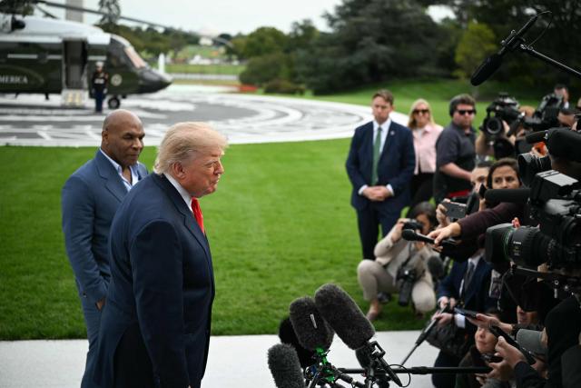 US President Donald Trump speaks to the press alongside former boxer Mike Tyson before boarding Marine One as he departs from the South Lawn of the White House in Washington, DC, on October 9, 2026. Trump is traveling to Syracuse, New York, to speak at a campaign rally. (Photo by Alex WROBLEWSKI / AFP)