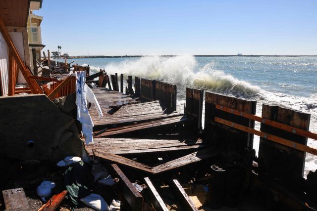Strong waves crash onto the boardwalk and beachfront houses in Long Beach, California, on October 9, 2026. The National Weather Service office in San Diego on October 9 issued a rare tropical storm watch for most of San Diego County, in Southern California, meaning that tropical storm-force winds are possible somewhere in the area over the next 48 hours. It’s only the second time a tropical storm watch has ever been issued in California. (Photo by David Swanson / AFP)