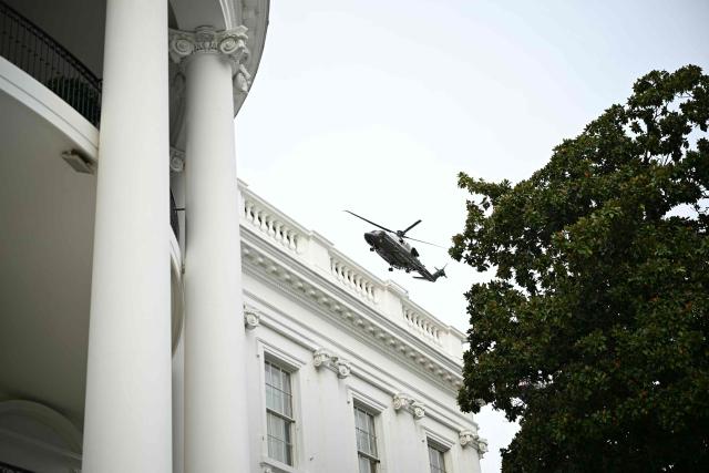 Marine One carrying US President Donald Trump flies above the White House as he departs for Syracuse, New York, in Washington, DC, on October 9, 2026. Trump is traveling to Syracuse, New York, to speak at a campaign rally. (Photo by Alex WROBLEWSKI / AFP)