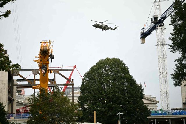 Marine One carrying US President Donald Trump flies over the construction site of the White House ballroom as he departs the White House in Washington, DC, on October 9, 2026. Trump is traveling to Syracuse, New York, to speak at a campaign rally. (Photo by Alex WROBLEWSKI / AFP)