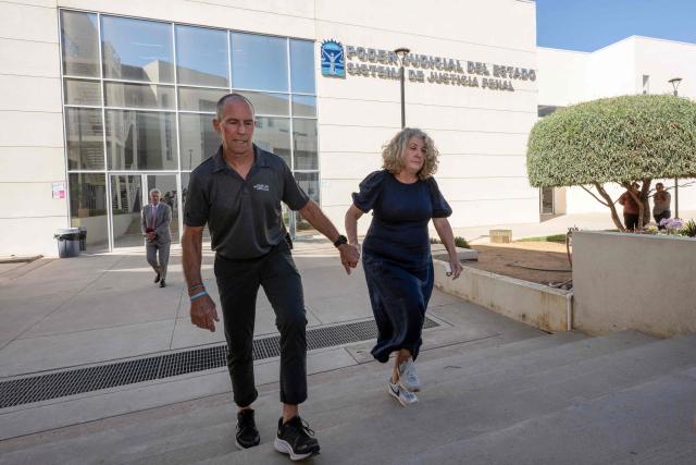 Debra (R) and Martin (L) Robinson, the parents of Australian brothers Callum and Jake Robinson, who were murdered during a surfing trip in April 2024, walk to speak to the media after three men were found guilty of their murders at the end of their trial in Ensenada, Baja California state, Mexico, on October 9, 2026. A Mexican judge is expected to deliver a verdict on October 9 in the high-profile trial of three men accused of murdering two Australian surfers and their US friend in 2024. (Photo by Guillermo Arias / AFP)