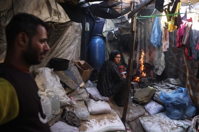 In this photo taken on October 6, 2026, Morsi and Nihaya Al-Masri, a displaced Palestinian couple from Beit Hanoun, are seen at their makeshift shelter in Khan Yunis, in the southern Gaza Strip. Every day, Gazan mother Niyaha al-Masri spends six exhausting hours or more queueing at a community kitchen in the hope of getting some food for her family. It has been a year since a ceasefire between Hamas and Israel was supposed to allow food to flood into the ruined territory, yet the hunger crisis there persists. (Photo by Bashar Taleb / AFP) / To go with 'ISRAEL-PALESTINIANS-CONFLICT-GAZA-HUNGER, FOCUS" by AFP team in Gaza, with Anouk RIONDET in Jerusalem