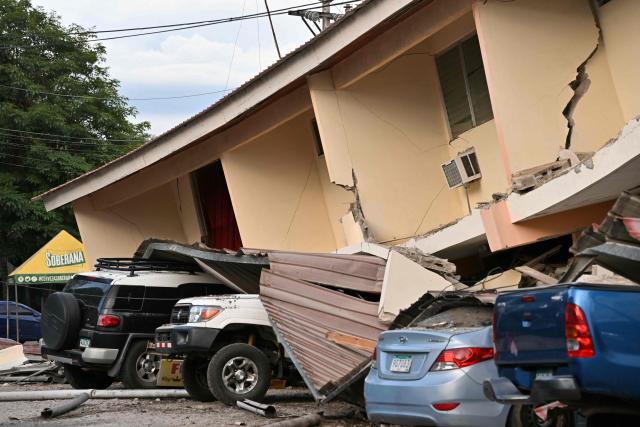 This view shows a collapsed building and damaged cars after a 7.6-magnitude earthquake struck the country, in Penonome, Panama, on October 9, 2026. According to the US Geological Survey (USGS), a magnitude 7.6 earthquake shook Panama sparking panic in the capital, though no casualties or damage have been reported so far. (Photo by MARTIN BERNETTI / AFP)