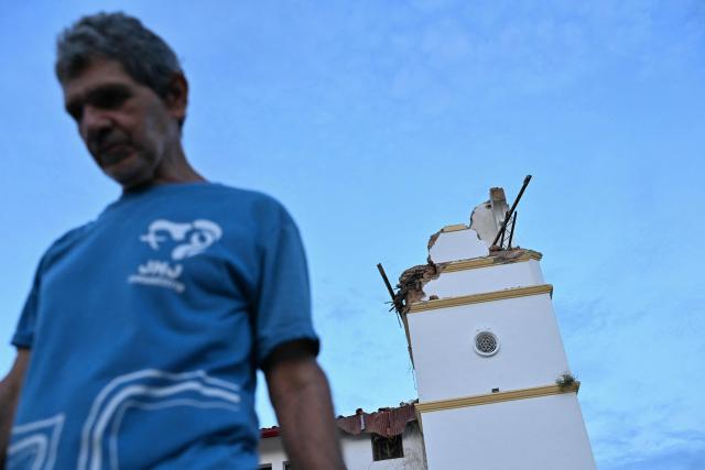 A man walks next to the collapsed Cathedral of Penonome after a 7.6-magnitude earthquake struck the country, in Penonome, Panama, on October 9, 2026. According to the US Geological Survey (USGS), a magnitude 7.6 earthquake shook Panama sparking panic in the capital, though no casualties or damage have been reported so far. (Photo by MARTIN BERNETTI / AFP)