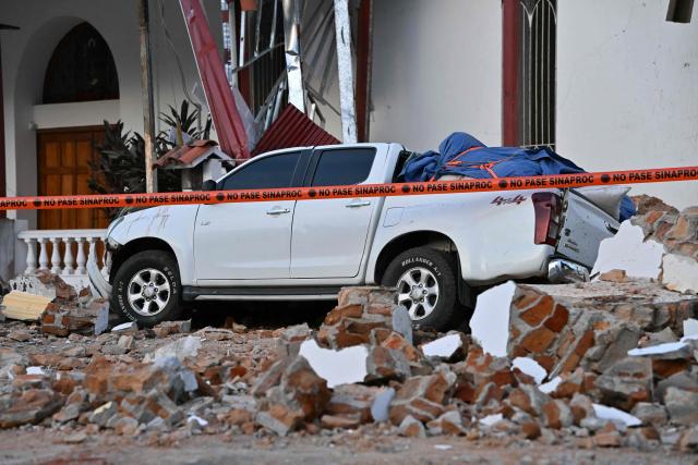 This view shows a collapsed building and a damaged car after a 7.6-magnitude earthquake struck the country, in Penonome, Panama, on October 9, 2026. According to the US Geological Survey (USGS), a magnitude 7.6 earthquake shook Panama sparking panic in the capital, though no casualties or damage have been reported so far. (Photo by MARTIN BERNETTI / AFP)