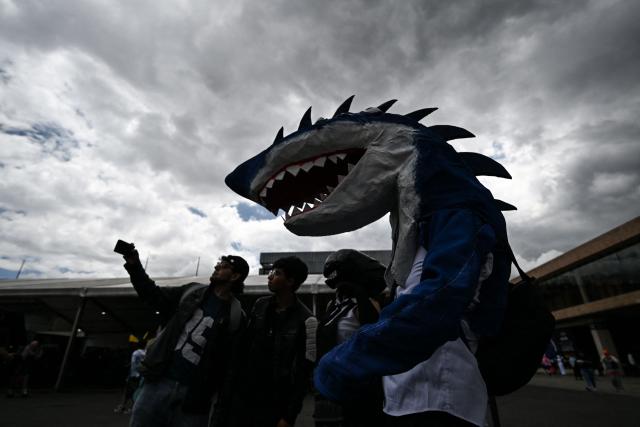 A man wearing a shark cosplay costume takes part in the SOFA Leisure and Fantasy Fair in Bogota on October 9, 2026. (Photo by Raul ARBOLEDA / AFP)