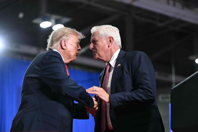 US President Donald Trump shakes hands with Republican candidate for New York governor Bruce Blakeman at a campaign rally at the Oncenter Convention Center in Syracuse, New York, on October 9, 2026. President Trump is campaigning for Blakeman, as well as other Republican candidates in November's general election. (Photo by Mandel NGAN / AFP)