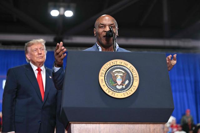 US former boxer Mike Tyson speaks while US President Donald Trump looks on at a campaign rally at the Oncenter Convention Center in Syracuse, New York, on October 9, 2026. President Trump is campaigning for Republican nominee for New York governor, Bruce Blakeman, as well as other Republican candidates in November's general election. (Photo by Mandel NGAN / AFP)