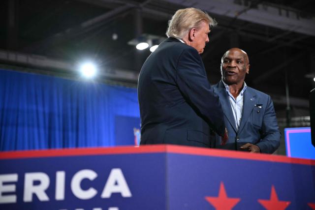US President Donald Trump shakes hands with US former boxer Mike Tyson ata campaign rally at the Oncenter Convention Center in Syracuse, New York, on October 9, 2026. President Trump is campaigning for Republican nominee for New York governor, Bruce Blakeman, as well as other Republican candidates in November's general election. (Photo by Mandel NGAN / AFP)