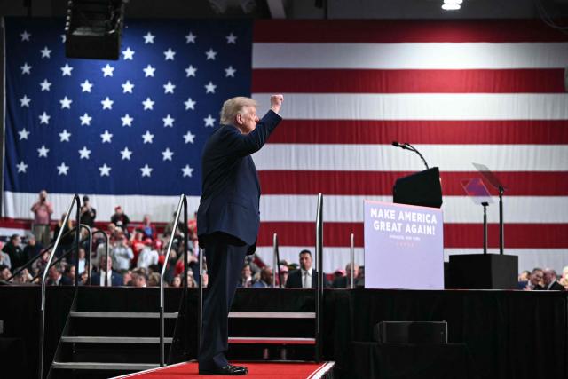 US President Donald Trump makes a fist as he walks off stage after speaking at a campaign rally at the Oncenter Convention Center in Syracuse, New York, on October 9, 2026. President Trump is campaigning for Republican nominee for New York governor, Bruce Blakeman, as well as other Republican candidates in November's general election. (Photo by Mandel NGAN / AFP)
