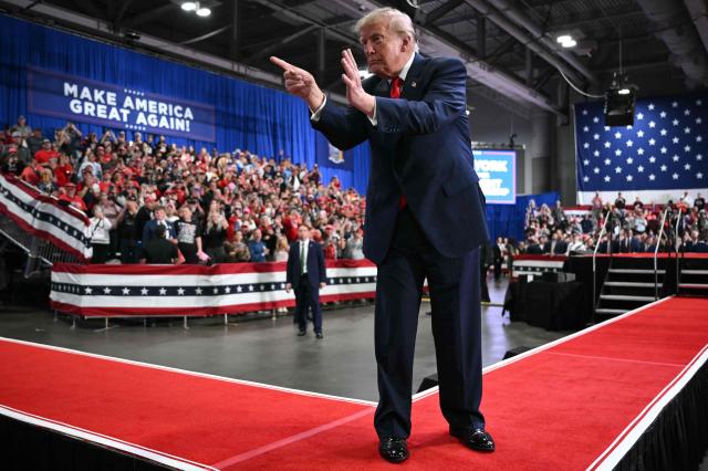 US President Donald Trump points to the crowd as he walks off stage after speaking at a campaign rally at the Oncenter Convention Center in Syracuse, New York, on October 9, 2026. President Trump is campaigning for Republican nominee for New York governor, Bruce Blakeman, as well as other Republican candidates in November's general election. (Photo by Mandel NGAN / AFP)