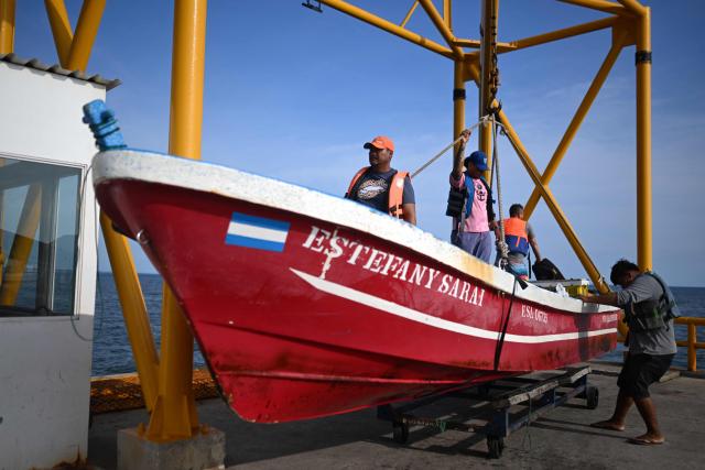 A fisherman move the boat is pulled out of the water at the end of the workday at the port of La Libertad, El Salvador, on October 9, 2026. (Photo by Marvin RECINOS / AFP)