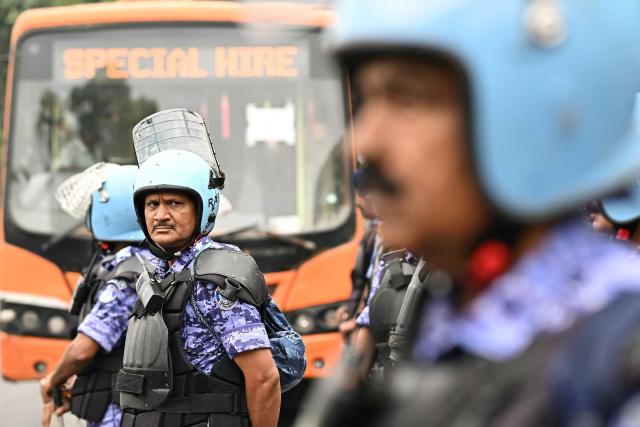 Rapid Action Force (RAF) personnel stand guard ahead of a protest by the youth-led Cockroach Janata Party (CJP) demanding the resignation of India’s Chief Election Commissioner over alleged "special intensive revision” (SIR) voter-roll irregularities,  in New Delhi on October 10, 2026. India deployed thousands of police in its capital and restricted transportation in and around Delhi ahead of mass demonstrations on October 10 demanding the resignation of the country's election chief over alleged voter-roll irregularities. (Photo by Manan VATSYAYANA / AFP)
