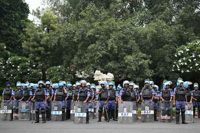 Rapid Action Force (RAF) personnel stand guard ahead of a protest by the youth-led Cockroach Janata Party (CJP) demanding the resignation of India’s Chief Election Commissioner over alleged "special intensive revision” (SIR) voter-roll irregularities, in New Delhi on October 10, 2026. India deployed thousands of police in its capital and restricted transportation in and around Delhi ahead of mass demonstrations on October 10 demanding the resignation of the country's election chief over alleged voter-roll irregularities. (Photo by Manan VATSYAYANA / AFP)